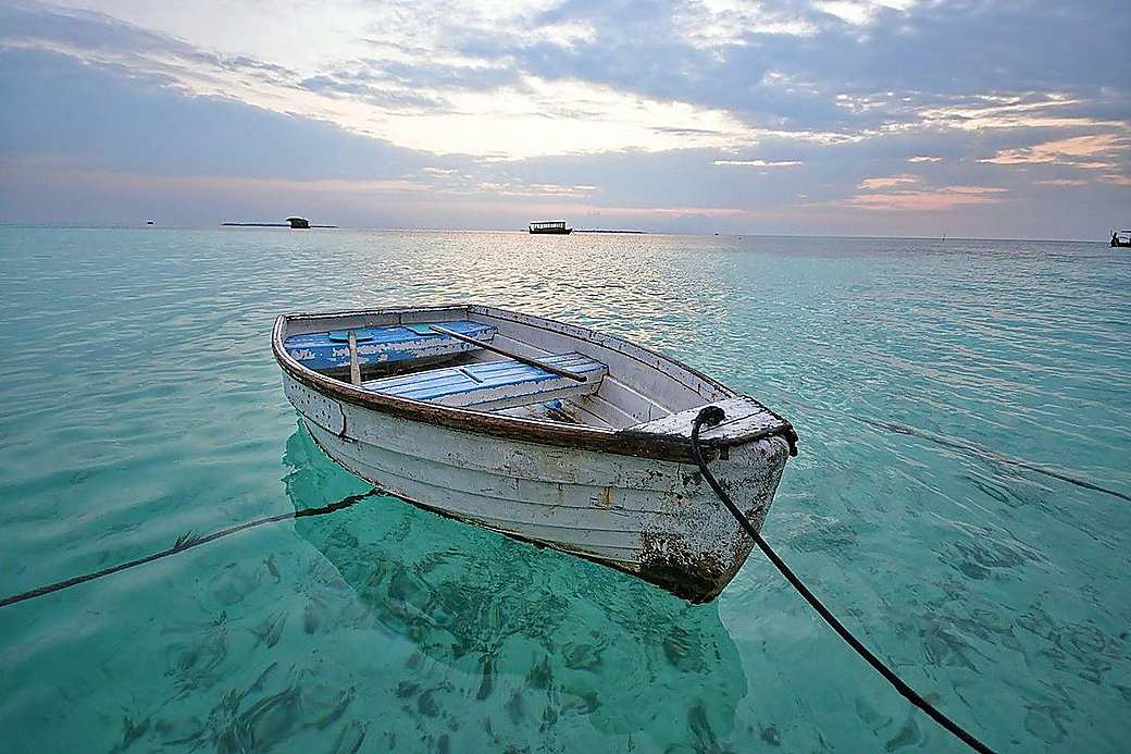 A wooden boat on calm turquoise water